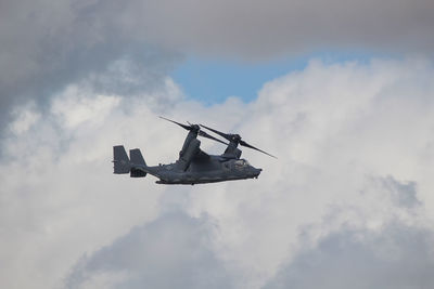 Low angle view of airplane flying against sky