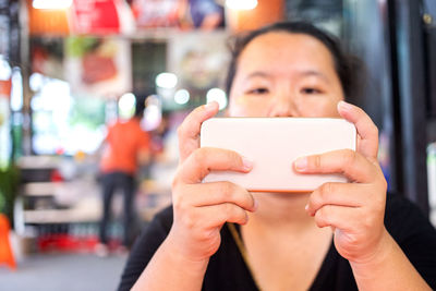 Close-up portrait of man using mobile phone