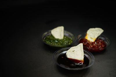 Close-up of food served on plate against black background