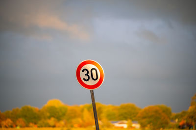 Road sign against sky