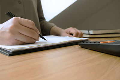 Midsection of man working on table