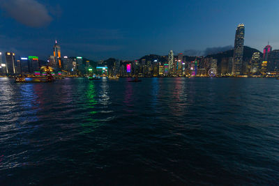 Illuminated city at waterfront