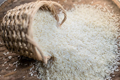 High angle view of rice spilling from basket