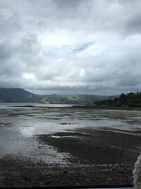 Scenic view of mountains against cloudy sky
