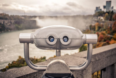 Close-up of binoculars against sky