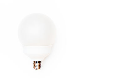 Close-up of light bulb over white background