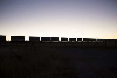 View of silhouette train against sky during sunset