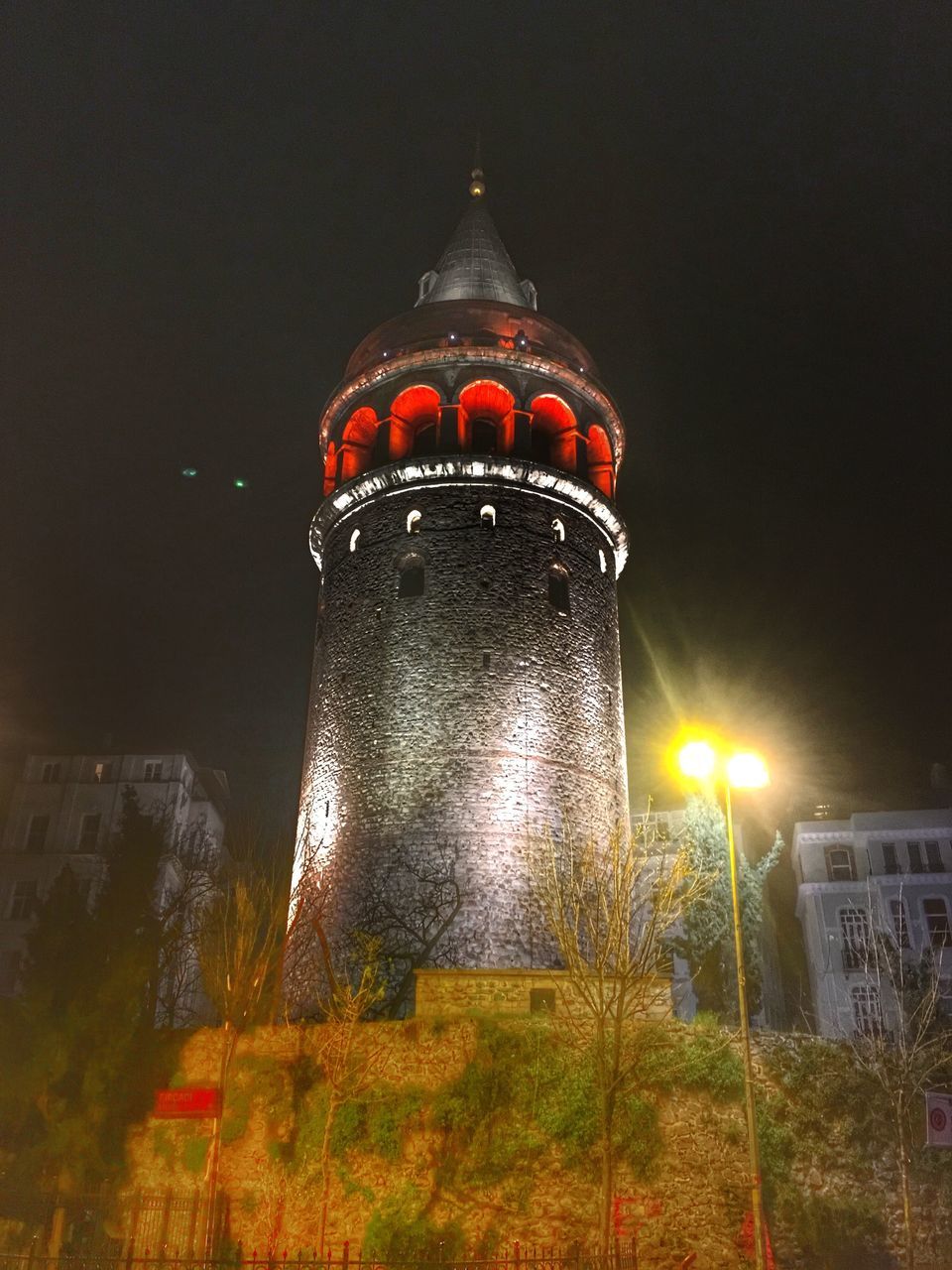 illuminated, tower, night, built structure, architecture, sky, building exterior, low angle view, tall - high, outdoors, tall, high section, no people, facade, spire