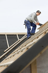 Man working on house roof