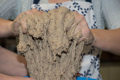 Close-up of woman hand holding mud