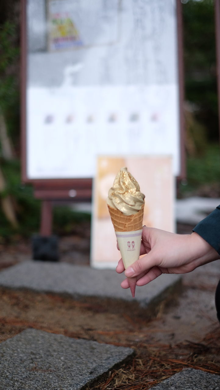 HAND HOLDING ICE CREAM