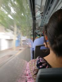 Rear view of woman sitting in train