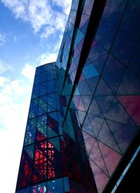 Low angle view of modern building against cloudy sky