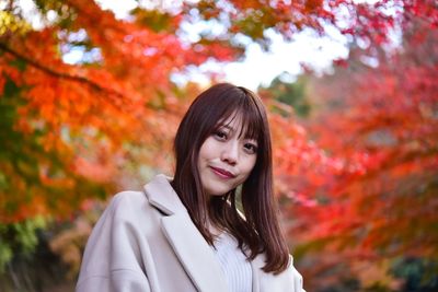 Portrait of smiling young woman during autumn