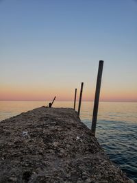 Scenic view of sea against clear sky at sunset