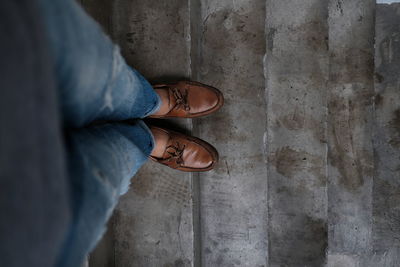 Low section of man standing on footpath