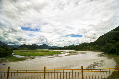 Scenic view of landscape and mountains against sky