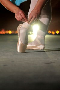 Low section of dancer wearing ballet shoes