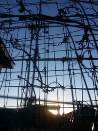 Low angle view of electricity pylon against sky