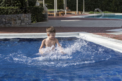 Full length of boy in swimming pool