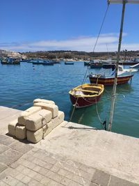 Sailboats moored in harbor