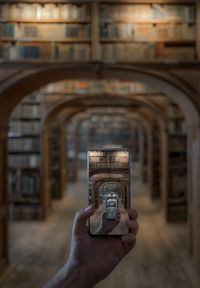 Man photographing through smart phone in building