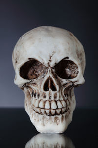 Close-up of a human skull over black background