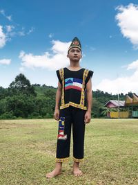 Full length portrait of muruts boy standing on field, sepulut nabawan sabah