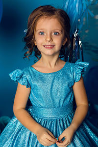 Girl in the blue dress in the studio with the balloon and with the number five