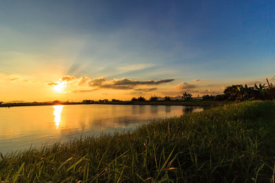 Scenic view of lake against sky during sunset