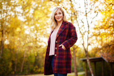 Portrait of young woman standing outdoors