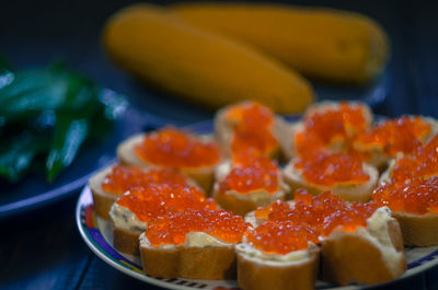 Close-up of chopped fruits in plate on table