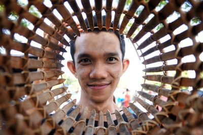 Portrait of smiling man looking through basket