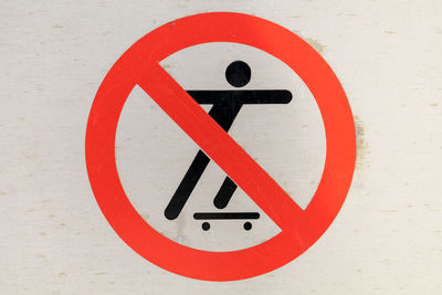 Close-up of no skateboarding sign on wall