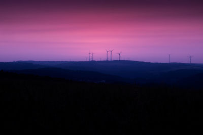 Colorful sunset with windmills on the horizon