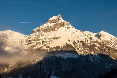 Scenic view of snowcapped mountains against clear blue sky