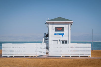 Built structure - lifeguard hut - on beach against sky