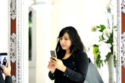 Close-up of young woman using mobile phone