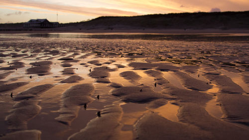 Scenic view of beach against sky during sunset