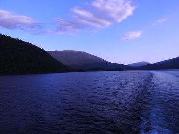 Scenic view of mountains against blue sky