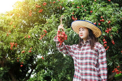 Full length of woman standing by plants