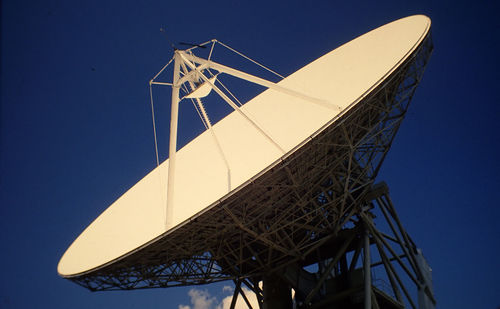 Low angle view of satellite dish against blue sky
