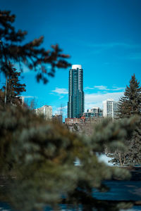 Buildings in city against blue sky