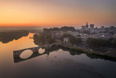 Bridge over river during sunset