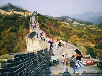 People on staircase against mountain
