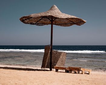 Lifeguard hut on beach against clear sky