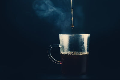 Close-up of coffee cup against black background