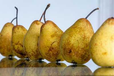 Close-up of pears on glass table