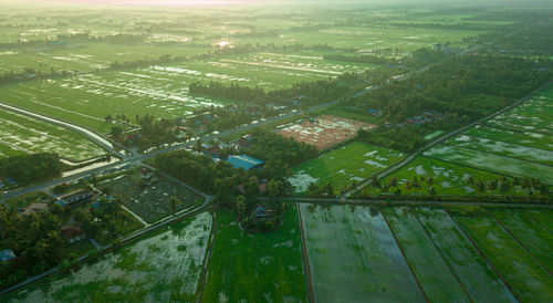 High angle view of agricultural field and buildings in city