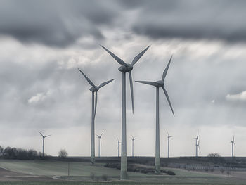 Windmill on field against sky